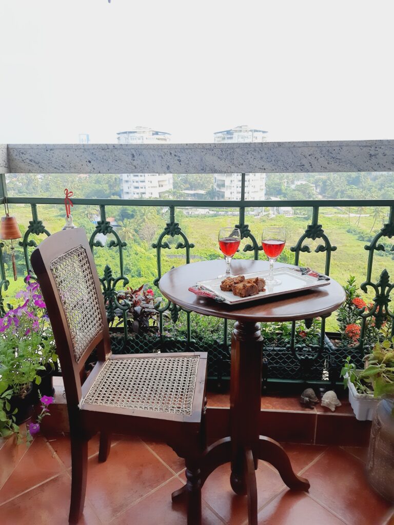 a small balcony with some greenery and flowers | Girija home tour in Kochi