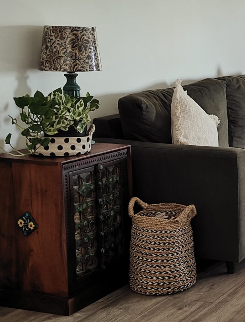 the sitting room corner with a side cupboard and rattan basket | Girija home tour in Kochi