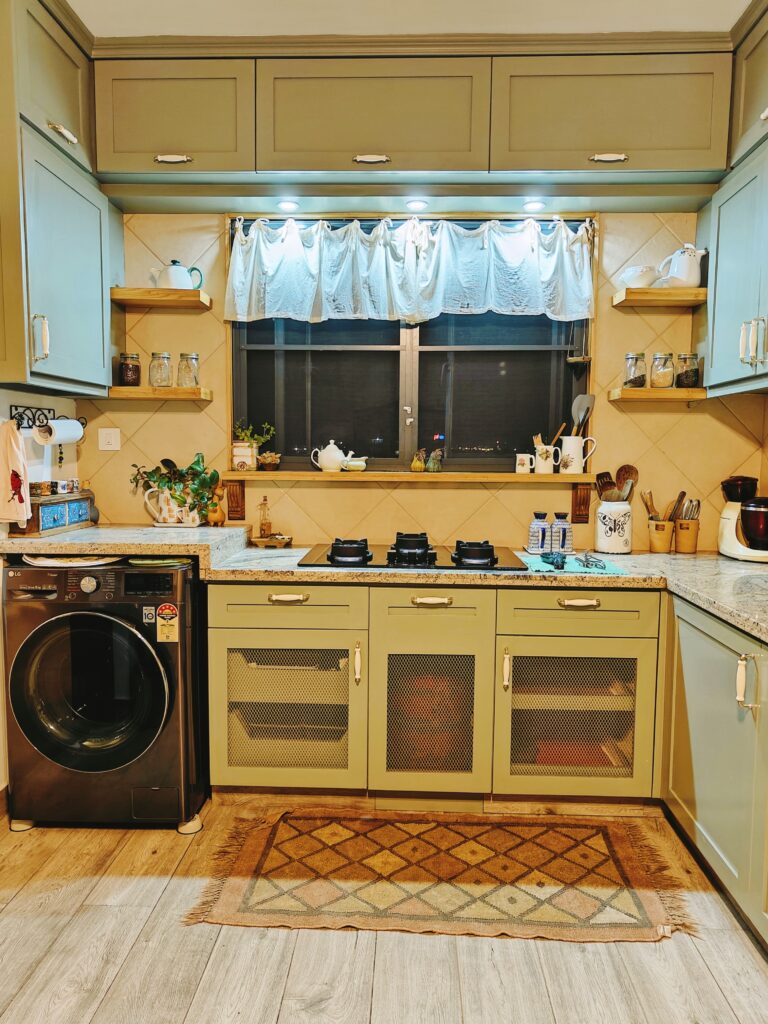 The cabinet underneath the cook top has iron net doors | Girija home tour in Kochi