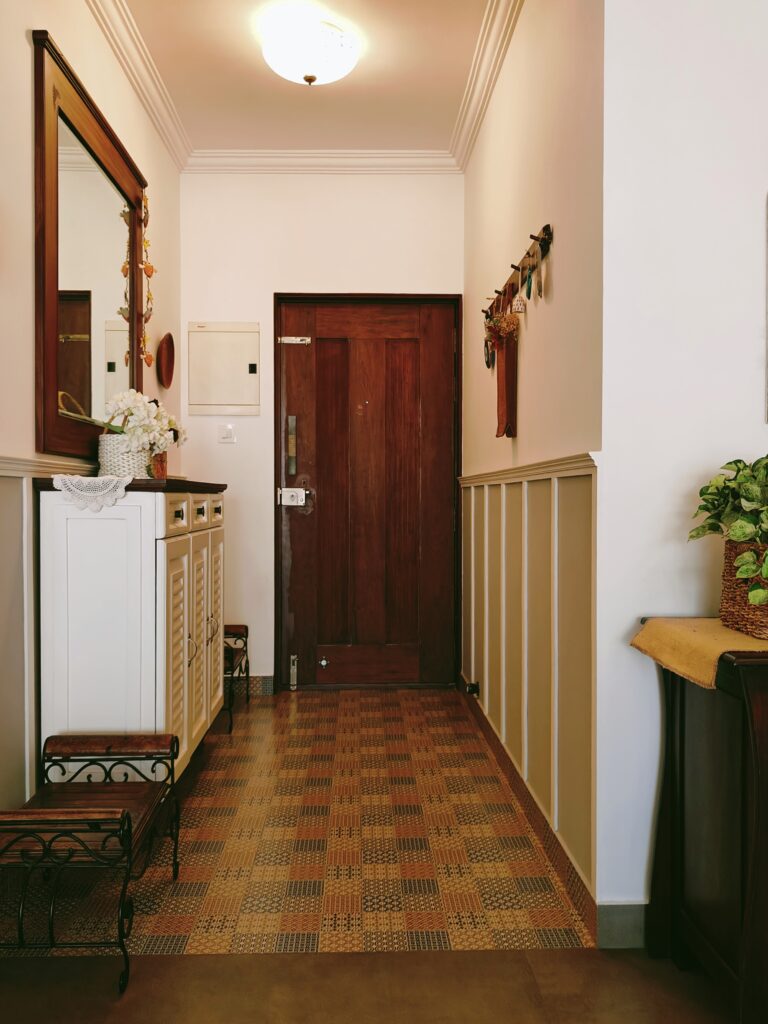 The entry way has a beautiful floor tiles and an abundance of white | Girija home tour in Kochi